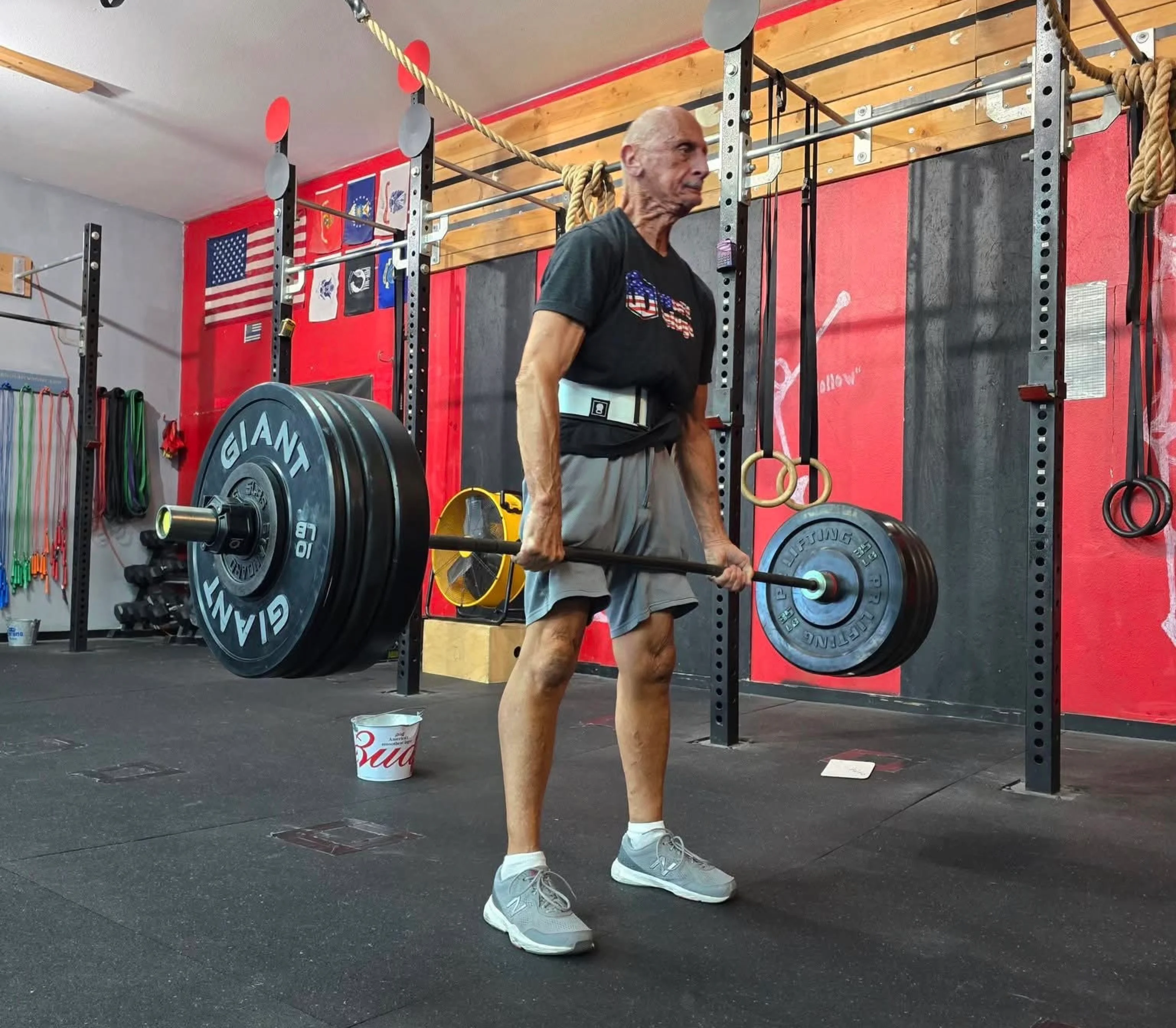 One-on-one personal training session showing coach helping athlete with proper form and technique